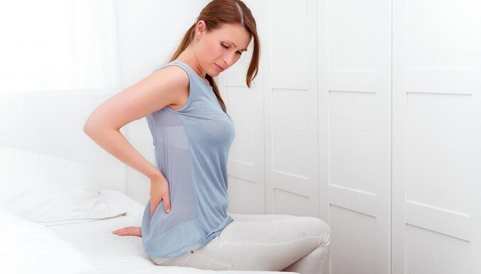 A woman is afraid of back pain
